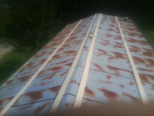 Rusted metal roof panels with new wood purlins before replacement — Storm Damage Roof Repair in Brush Valley by Roofing Brothers