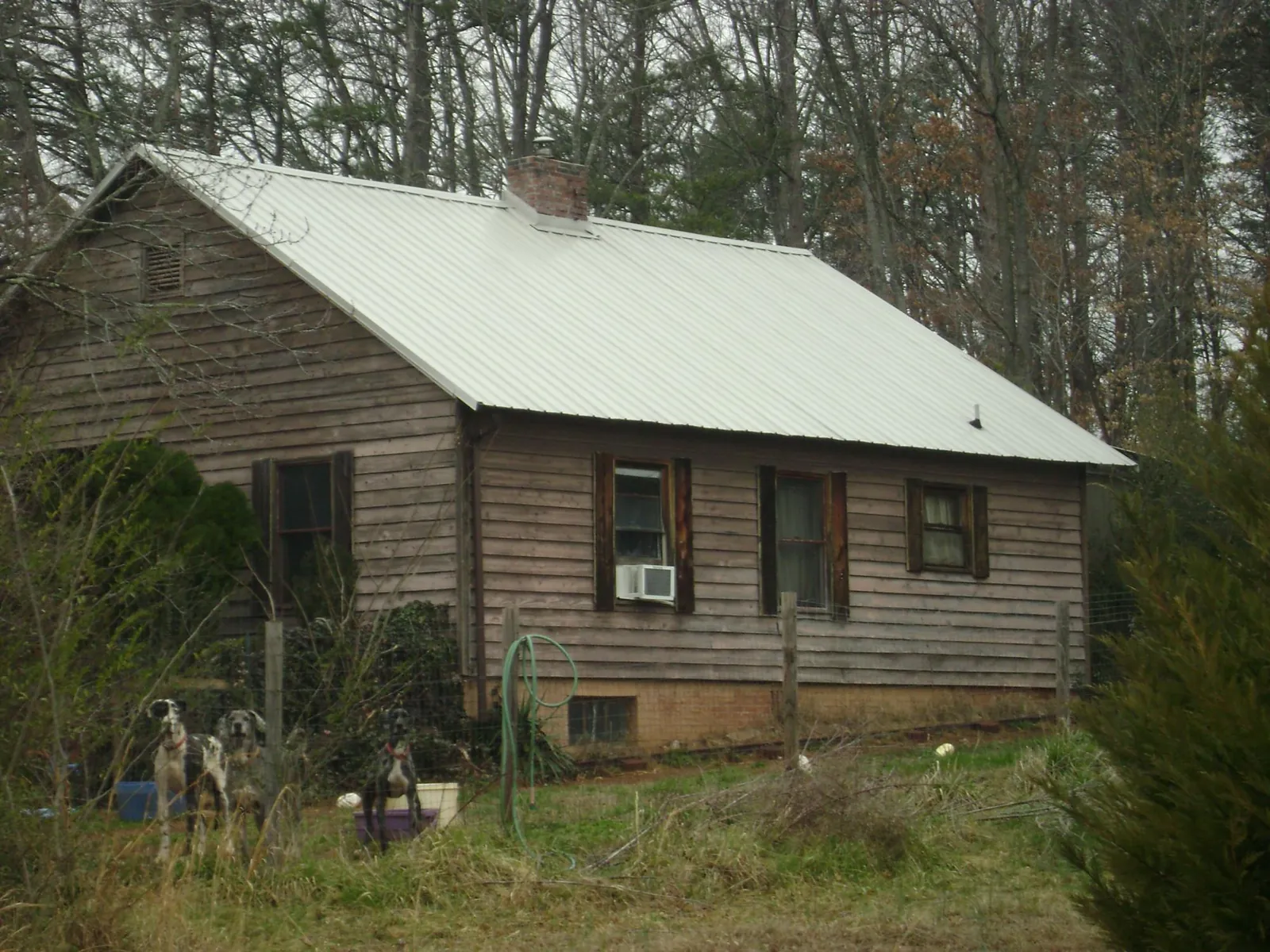 White metal roof on an old wood sided farmhouse, from a Metal Roof Installation job in Brush Valley
